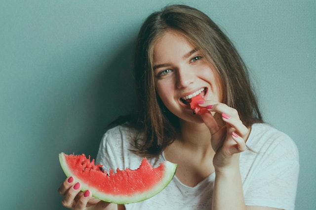 Woman Wearing White Shirt Eating Watermelon