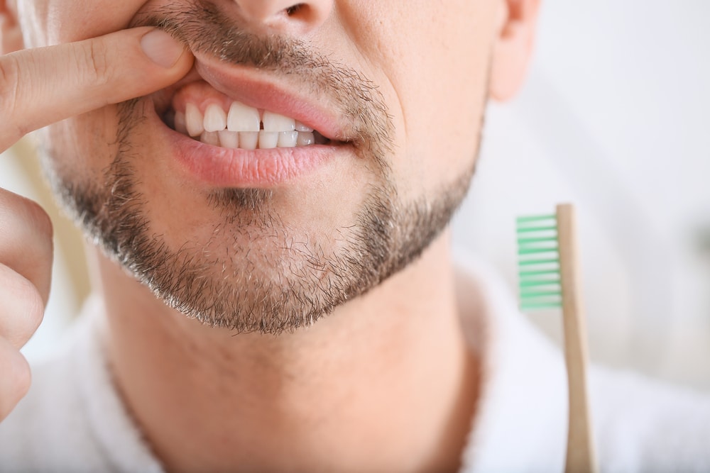 Man showing his gums after gum disease treatment in Milwaukee, WI