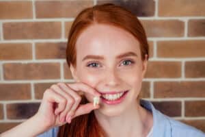 Girl holding her tooth after wisdom tooth extraction in Milwaukee, WI