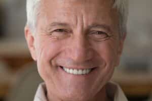 Elderly man smiling with dentures in Milwaukee, WI